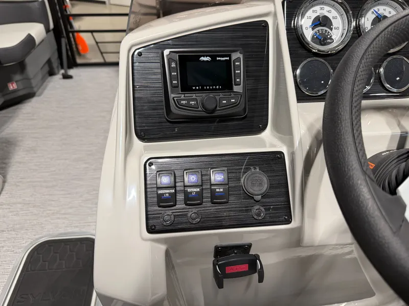 Slide: The Image of The image shows the dashboard of a 2026 Sylvan MIRAGE X3 DLZ BAR with controls and gauges. - 16