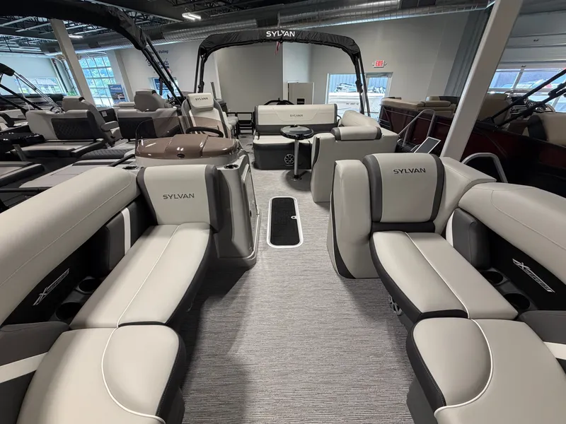 Slide: The Image of The image shows the interior of a Sylvan MIRAGE X3 DLZ BAR pontoon boat with luxurious seating. - 7
