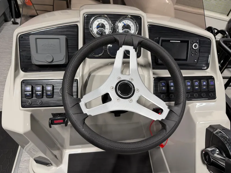 Slide: The Image of Helm of a 2026 Sylvan MIRAGE X3 DLZ BAR with modern instruments and controls. - 15