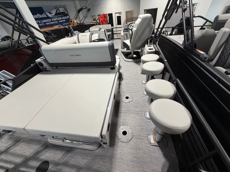 Slide: The Image of Interior view of a 2026 Sylvan MIRAGE X3 DLZ BAR with seating and helm station. - 21
