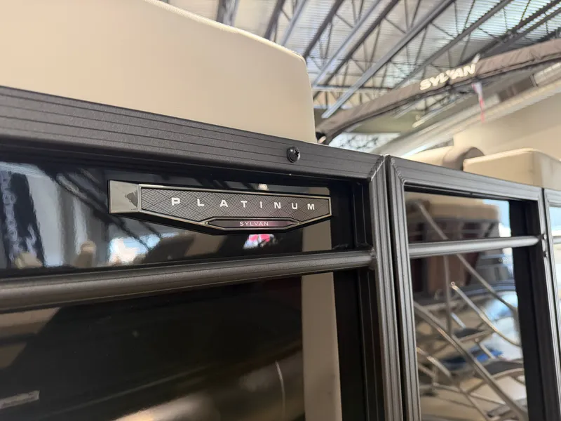 Slide: The Image of Close-up of a Sylvan Mirage X3 DLZ BAR boat with a "Platinum" badge. - 2