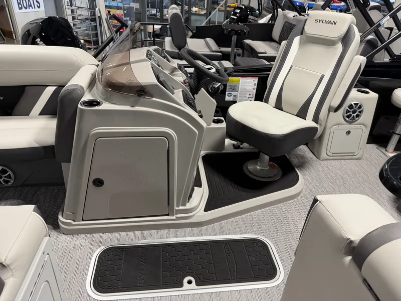 Slide: The Image of The image shows the cockpit of a 2026 Sylvan MIRAGE X3 DLZ BAR with a modern helm and comfortable seating. - 12
