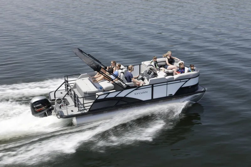 Slide: The Image of A 2026 Sylvan L3 DLZ cruising on calm waters with several people on board. - 1