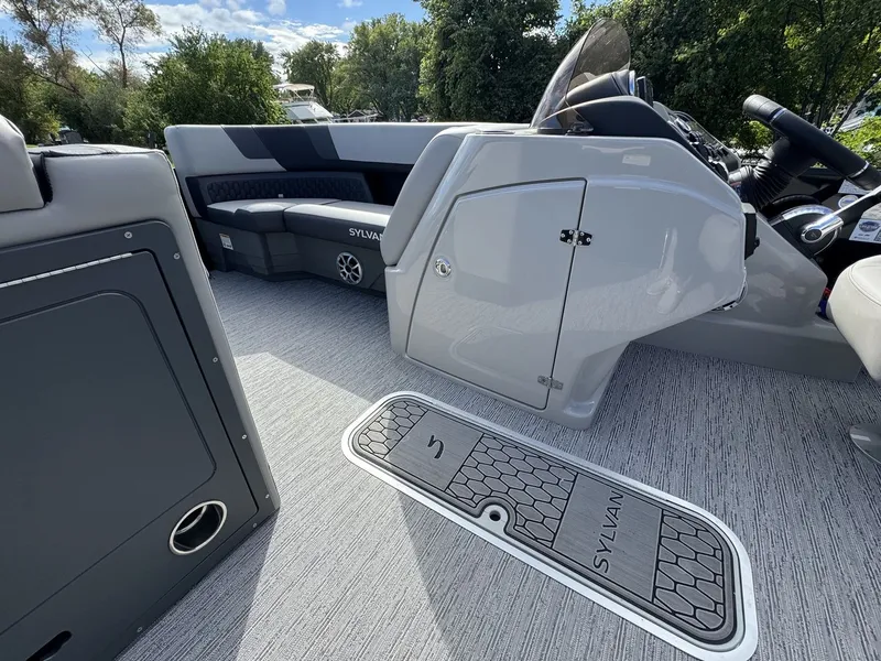 Slide: The Image of The image shows the interior of a Sylvan L3 DLZ boat with gray flooring and modern seating. - 20