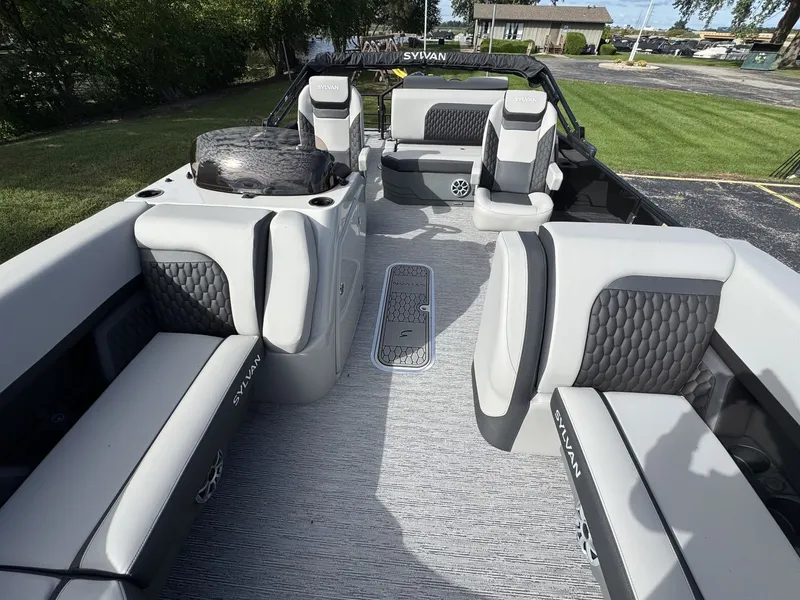Slide: The Image of The image shows the interior of a 2026 Sylvan L3 DLZ boat with gray and black seating. - 27