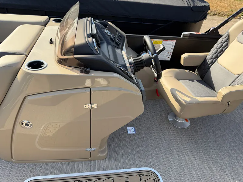 Slide: The Image of The image shows the cockpit of a 2026 Sylvan L3 DLZ with a beige dashboard and gray seat. - 16