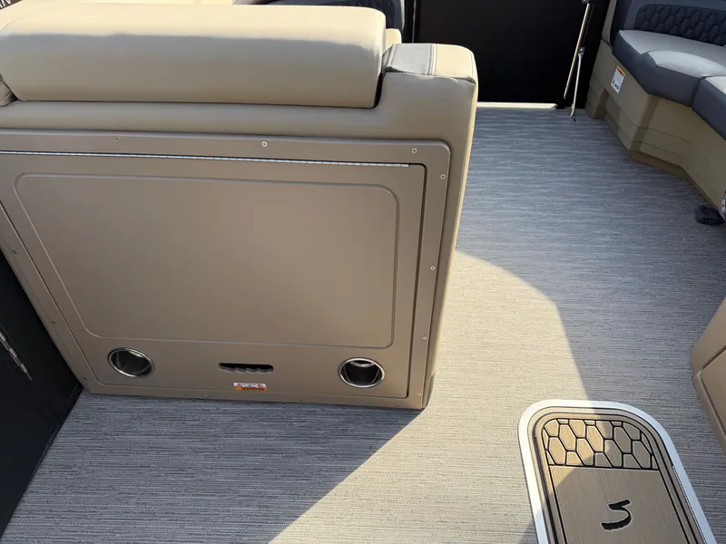 Slide: The Image of Interior of a 2026 Sylvan L3 DLZ with beige upholstery and carpeted flooring. - 14