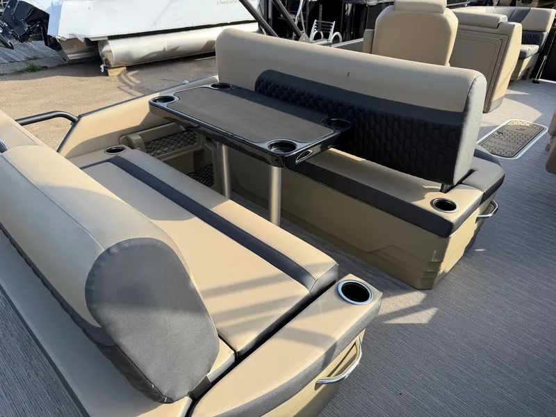 Slide: The Image of Interior of a 2026 Sylvan L3 DLZ with beige and gray seating and a table. - 25