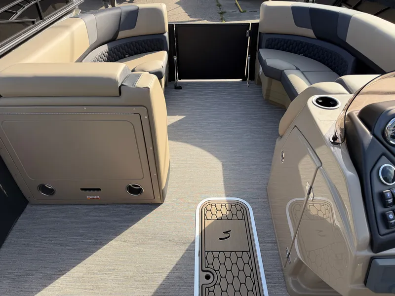Slide: The Image of The image shows the interior of a Sylvan L3 DLZ pontoon boat with beige and gray seating. - 13