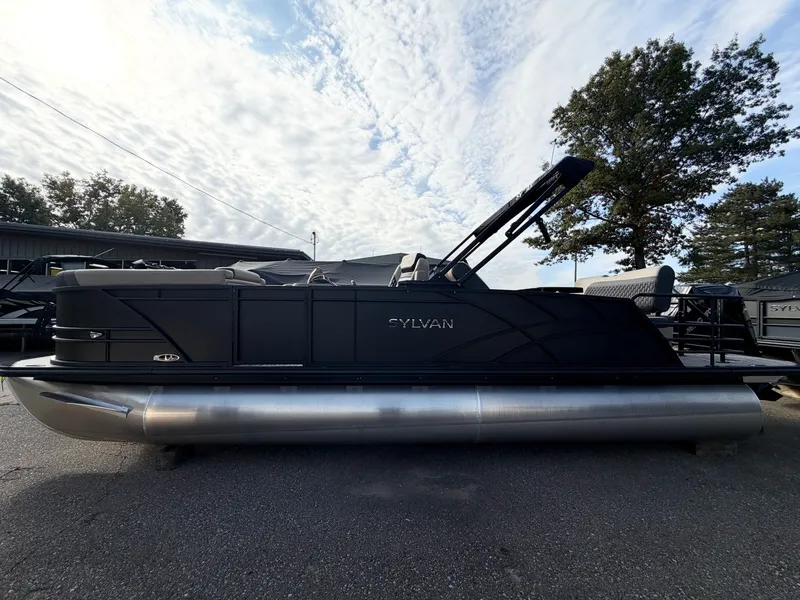 The Image of The image shows a modern pontoon boat by Sylvan, model L3 DLZ, year 2026, on a parking lot. - 0