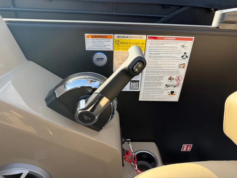 Slide: The Image of Close-up of the throttle lever on a 2026 Sylvan L3 DLZ boat. - 23