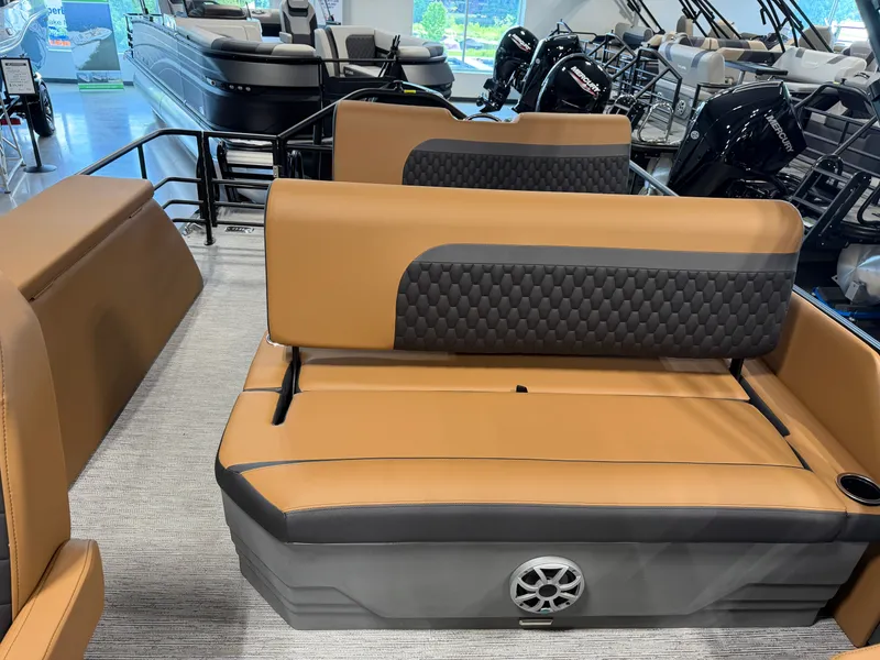 Slide: The Image of The image shows the interior of a Sylvan L3 DLZ boat with brown and gray seating. - 23