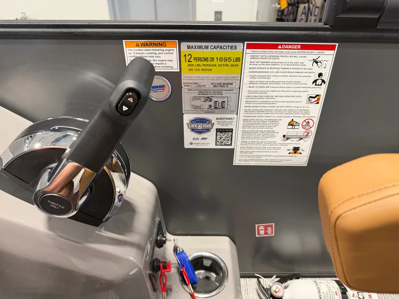 Slide: The Image of Close-up of a Sylvan L3 DLZ helm with warning labels and capacity information. - 18