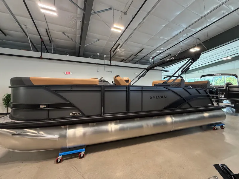 The Image of The image shows a modern Sylvan pontoon boat, model L3 DLZ, year 2026, in a showroom. - 0
