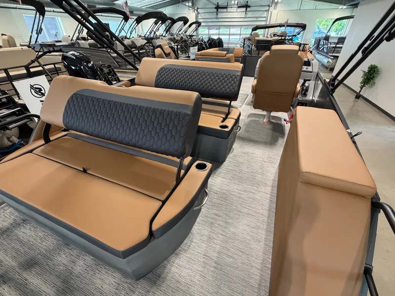 Slide: The Image of The image shows the interior of a 2026 Sylvan L3 DLZ with sleek, brown seating. - 26