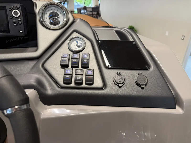 Slide: The Image of The image shows the dashboard of a Sylvan L3 DLZ boat with various switches and gauges. - 17
