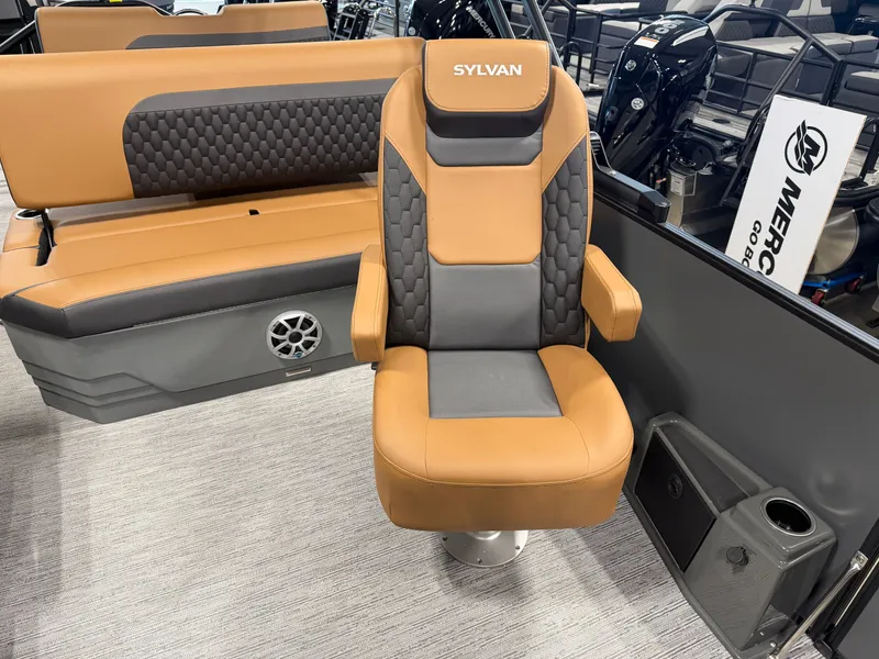 Slide: The Image of The interior of a 2026 Sylvan L3 DLZ features a swivel captain's chair and cushioned bench seating. - 19