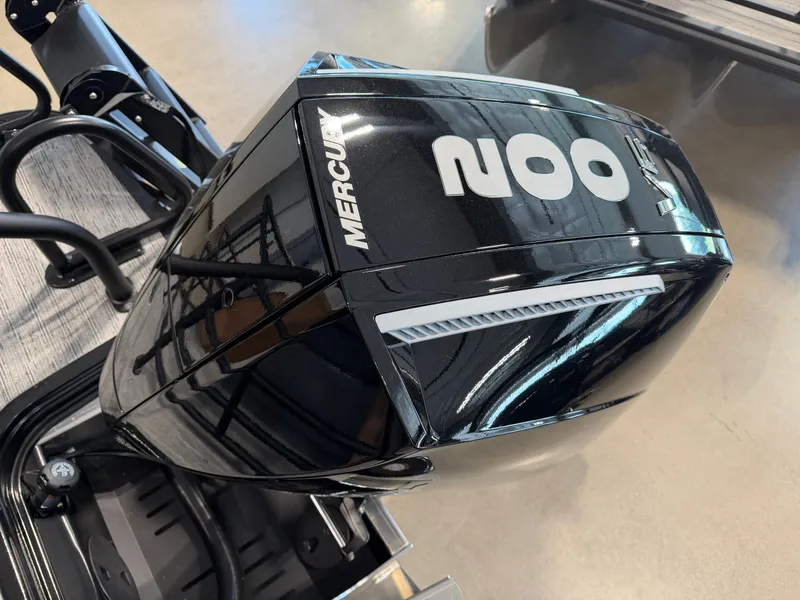 Slide: The Image of A Mercury outboard motor is mounted on a boat. The motor has a sleek black casing. - 27
