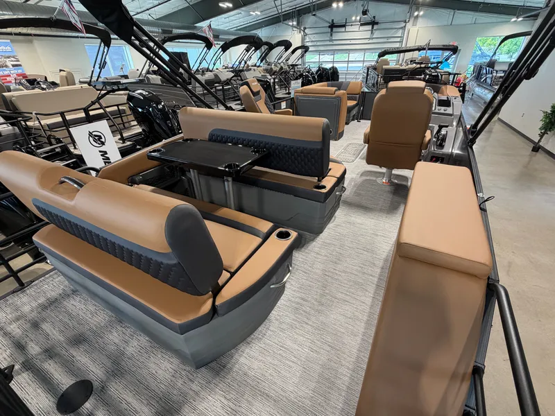 Slide: The Image of Interior of a Sylvan L3 DLZ pontoon boat with beige seating and a table. - 24
