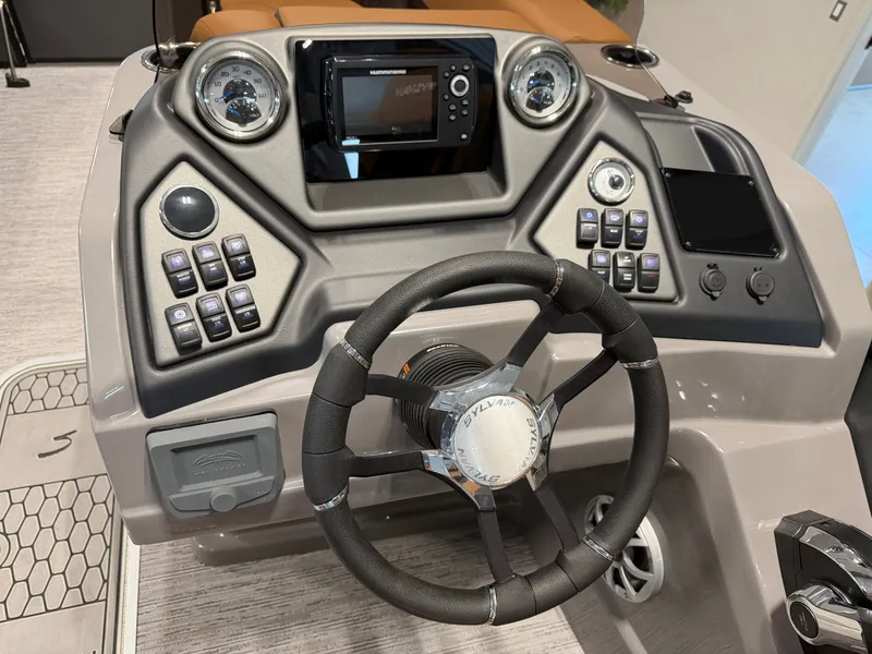 Slide: The Image of The image shows the helm of a 2026 Sylvan L3 DLZ boat with modern controls. - 14