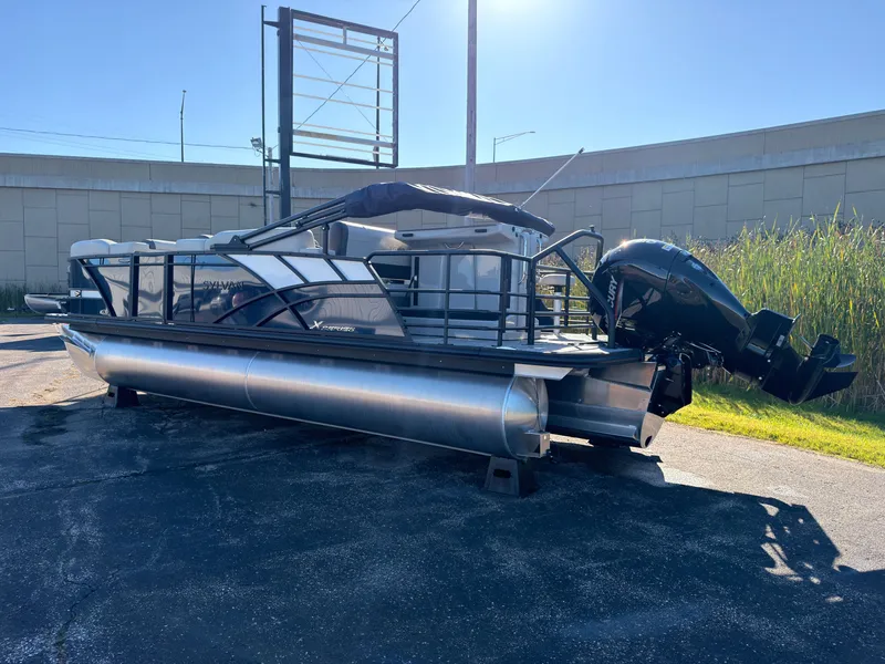 Slide: The Image of A 2026 Sylvan MIRAGE X3 DLZ BAR pontoon boat is parked on a lot. - 3