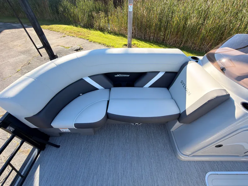Slide: The Image of The image shows a gray, cushioned seating area on a boat. - 19