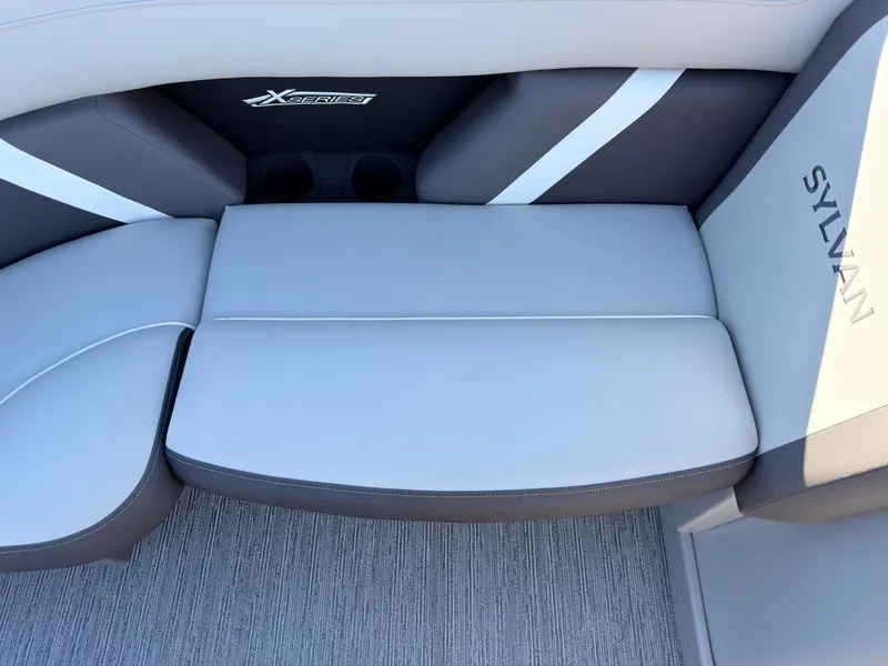 Slide: The Image of The 2026 Sylvan Mirage X3 DLZ Bar features a sleek, cushioned bench seat with cup holders. - 22
