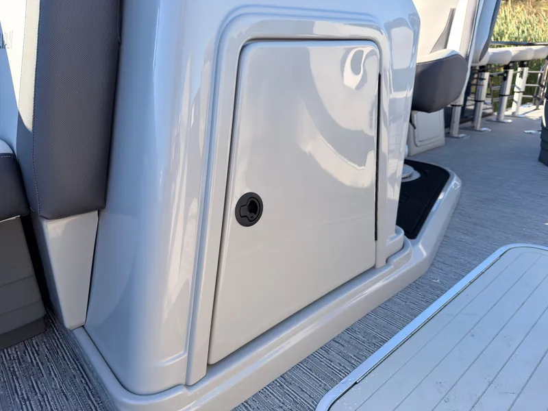 Slide: The Image of Close-up of a storage compartment on a 2026 Sylvan MIRAGE X3 DLZ BAR boat. - 26