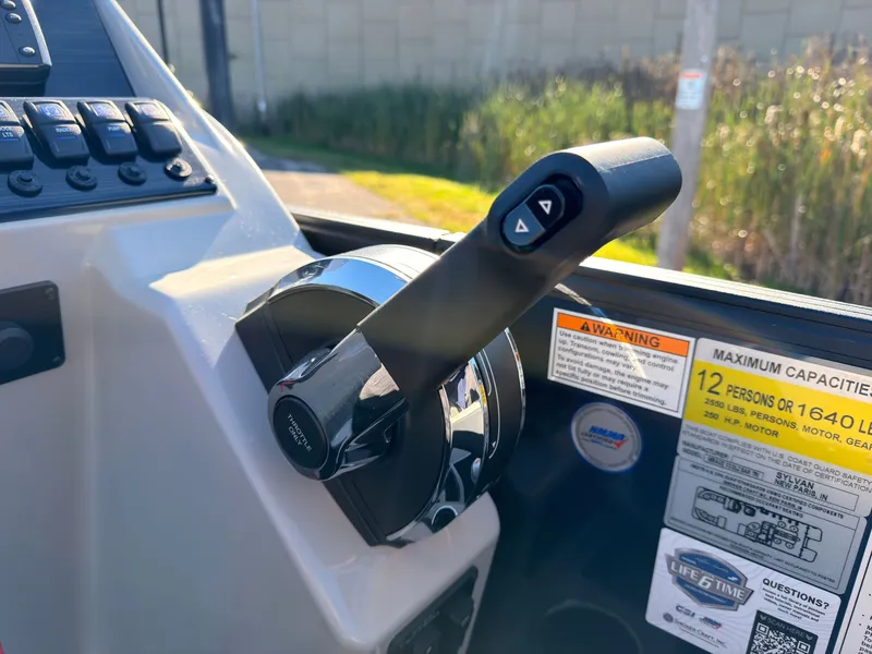 Slide: The Image of Close-up of a throttle lever on a Sylvan MIRAGE X3 DLZ BAR boat. - 42