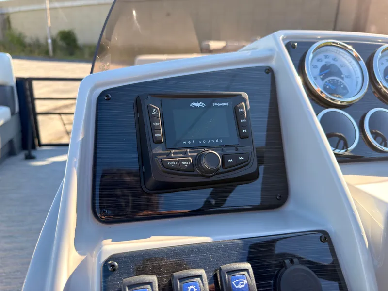 Slide: The Image of Close-up of a boat console area featuring a Wet Sounds audio system and various switches. - 37