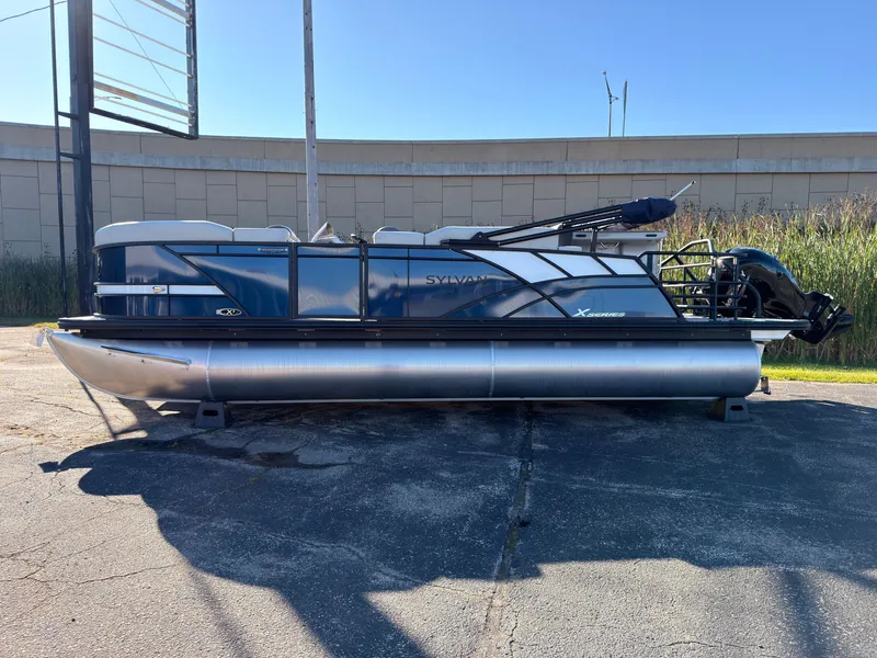 Slide: The Image of A modern pontoon boat with a blue hull and silver pontoons, featuring an outboard motor. - 2