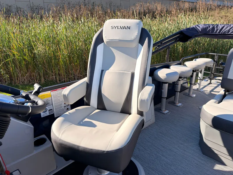 Slide: The Image of The 2026 Sylvan MIRAGE X3 DLZ BAR features a luxurious captain's chair and a bar with stools. - 32