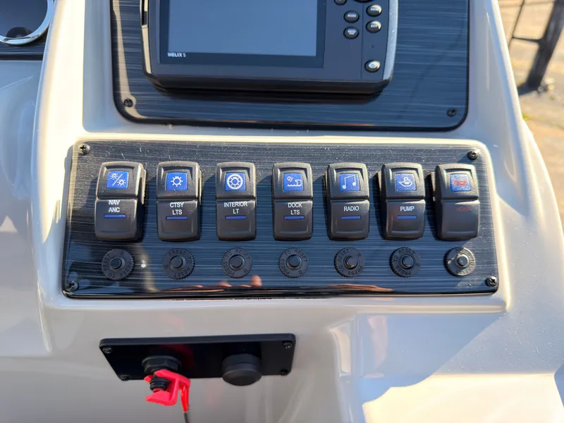 Slide: The Image of Close-up of a boat control panel with various switches and a display screen. - 40
