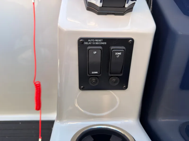 Slide: The Image of Close-up of a control panel with "Up/Down" and "Dome Lt" switches on a Sylvan boat. - 43