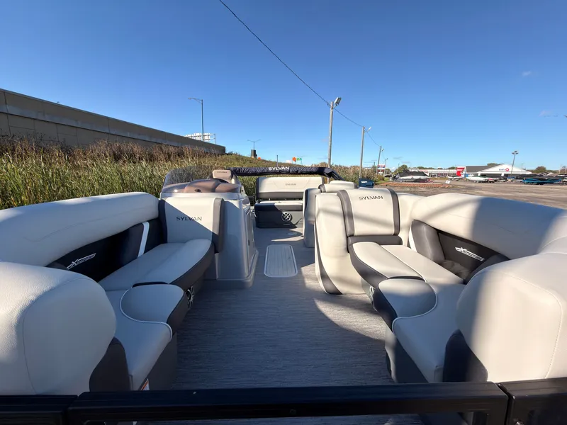 Slide: The Image of The image shows the interior of a 2026 Sylvan MIRAGE X3 DLZ BAR with luxurious seating. - 9