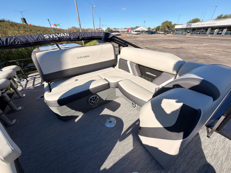 Slide: The Image of The image shows the spacious seating area of a Sylvan MIRAGE X3 DLZ BAR boat with comfortable upholstery. - 46