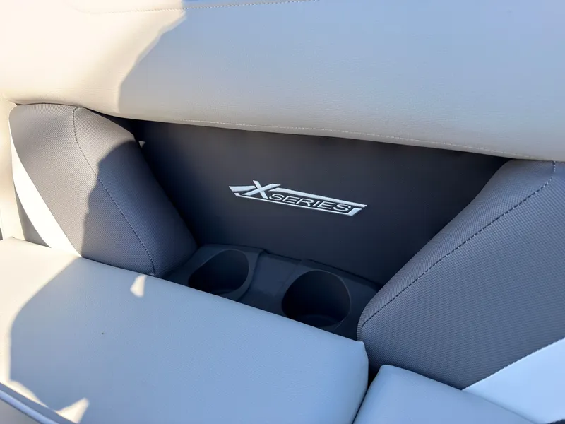 Slide: The Image of Close-up of a boat seat with "X Series" logo and cup holders. - 18