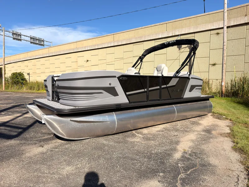 Slide: The Image of The image shows a modern Sylvan pontoon boat, model R-20 Q DH, year 2027, on a parking lot. - 5
