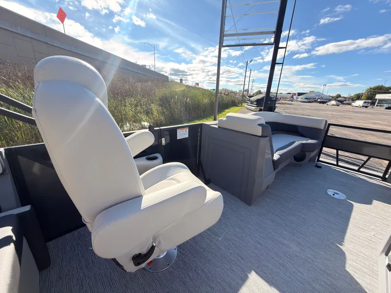 Slide: The Image of The image shows the deck of a 2027 Sylvan R-20 Q DH boat with white seating. - 23