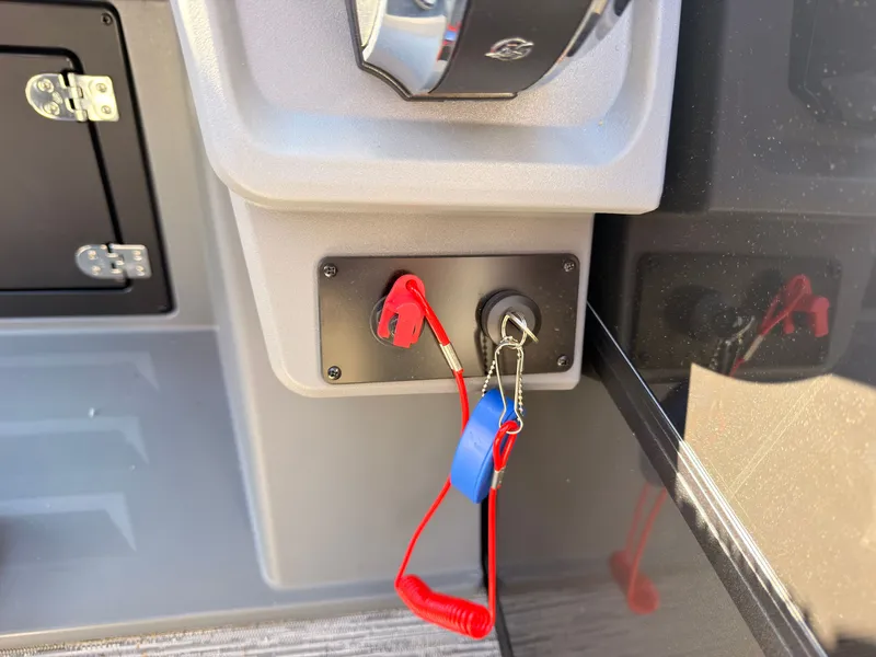 Slide: The Image of Close-up of a boat ignition switch with safety lanyard and key. - 34