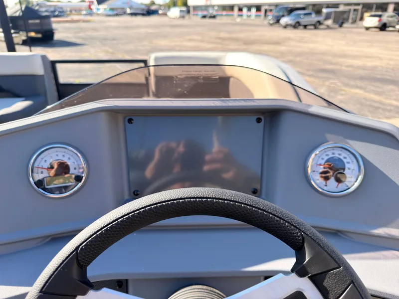 Slide: The Image of The image shows the dashboard of a Sylvan R-20 Q DH boat with two round gauges. - 31