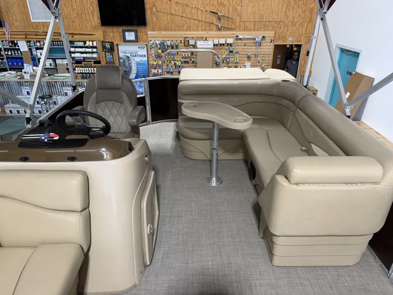 Slide: The Image of Interior of a 2016 Bennington 20SLX pontoon boat with beige seating. - 7