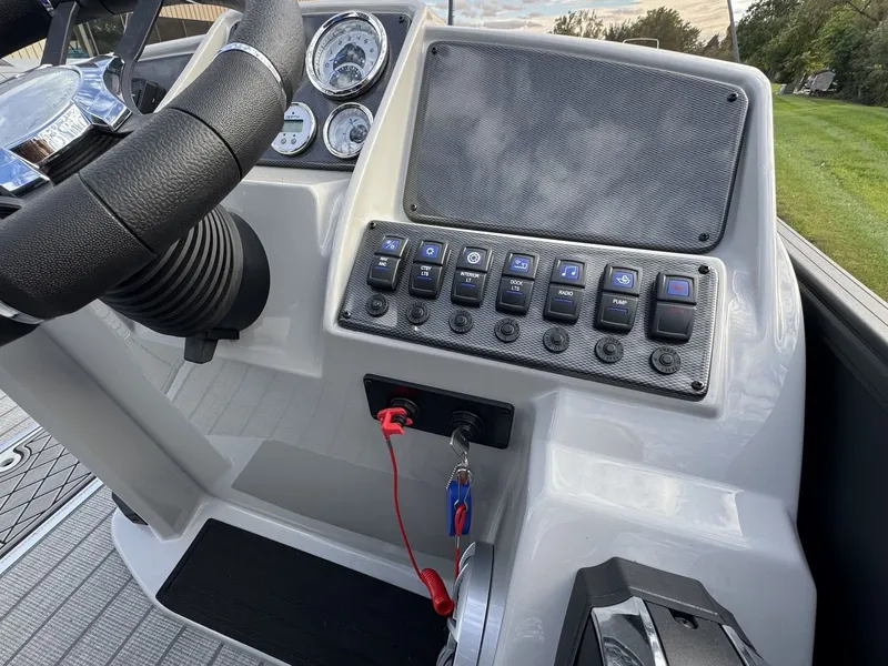 Slide: The Image of The image shows the helm of a Starcraft EXS 3 DL boat with switches and an ignition key. - 17