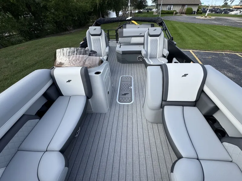 Slide: The Image of The image shows the spacious deck of a Starcraft EXS 3 DL boat with sleek gray seating. - 29