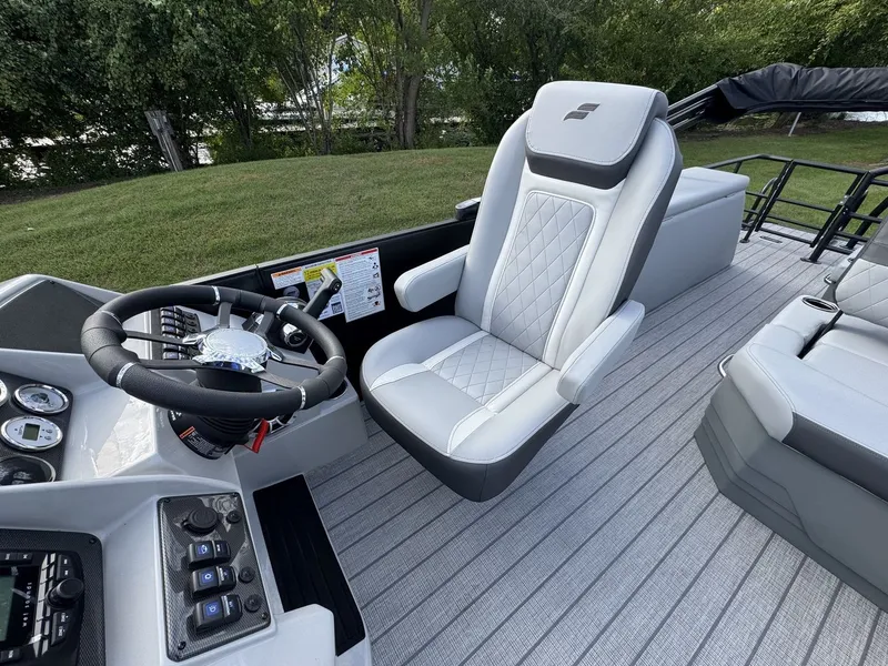 Slide: The Image of The image shows the helm of a 2027 Starcraft EXS 3 DL with a sleek, upholstered seat. - 13