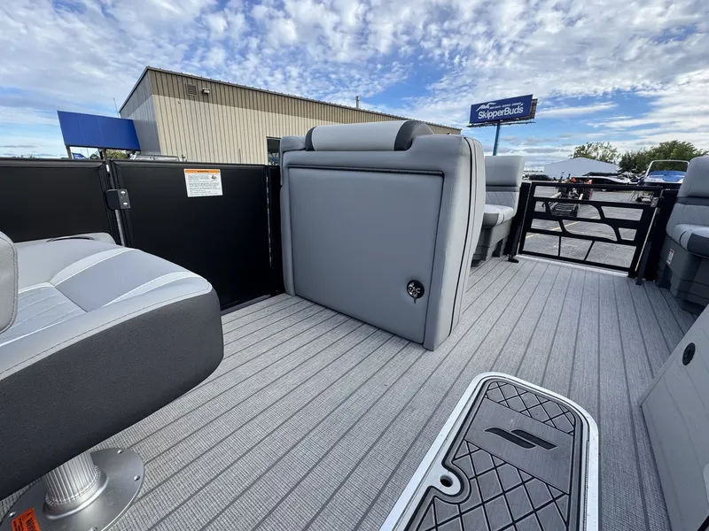 Slide: The Image of The image shows the interior of a 2027 Starcraft EXS 3 DL boat with gray seating and flooring. - 22