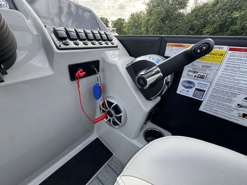 Slide: The Image of The image shows the helm of a Starcraft EXS 3 DL boat with throttle and controls. - 18