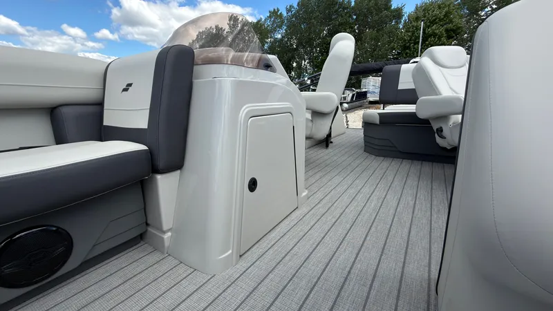 Slide: The Image of The image shows the interior of a 2027 Starcraft EX 20 Q DH boat with gray seating and flooring. - 24