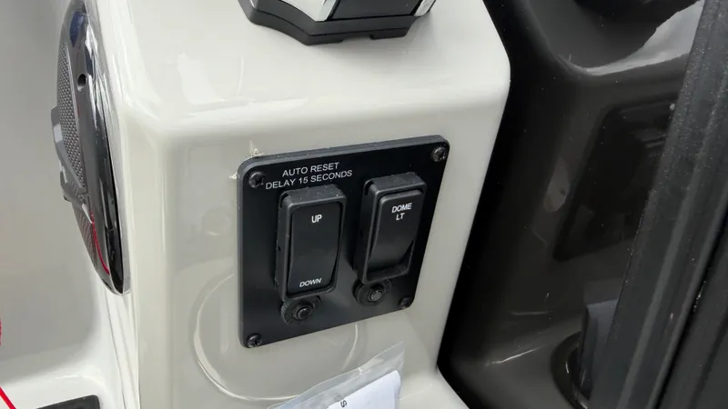 Slide: The Image of Close-up of a control panel with switches labeled "UP" and "DOME LT" on a boat. - 39