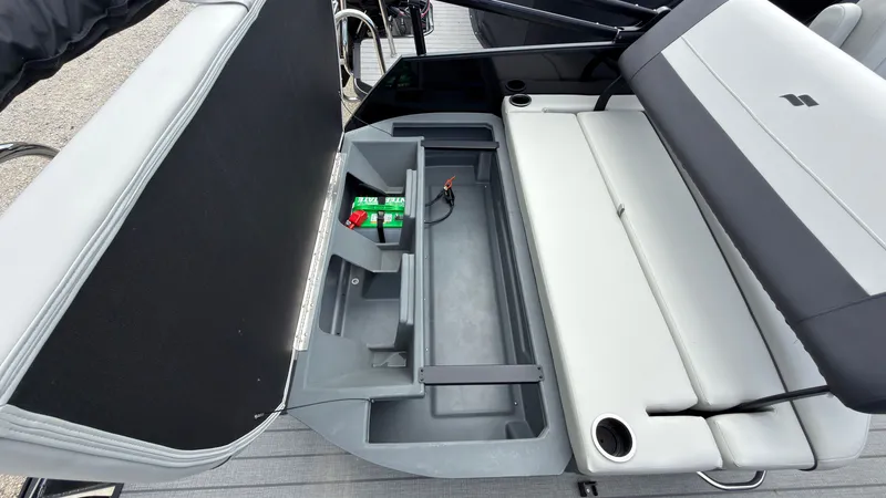 Slide: The Image of The image shows the storage area of a Starcraft EX 20 Q DH boat with batteries and seating. - 47